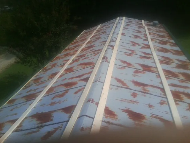 Rusted metal roof panels with new wood purlins before replacement — Storm Damage Roof Repair in Lisbon Falls by Roofing Brothers
