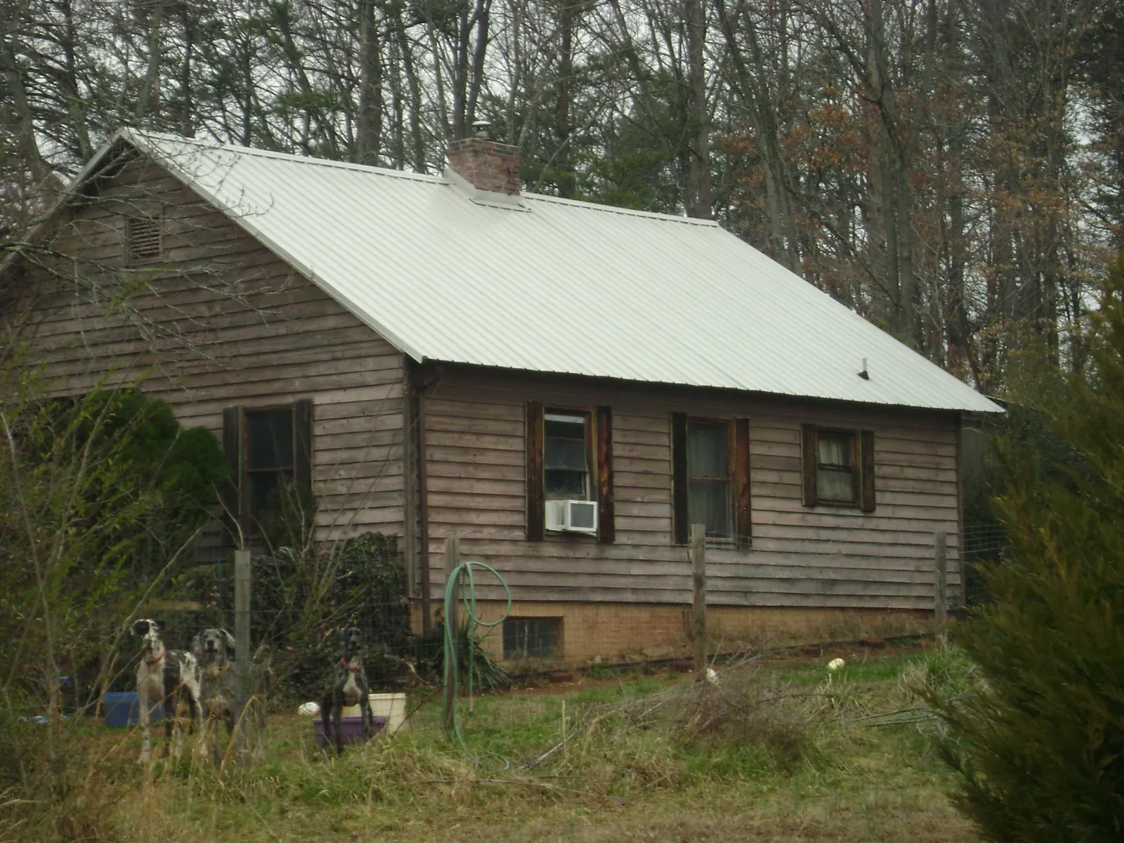 White metal roof on an old wood sided farmhouse, from a Metal Roof Installation job in Lisbon Falls